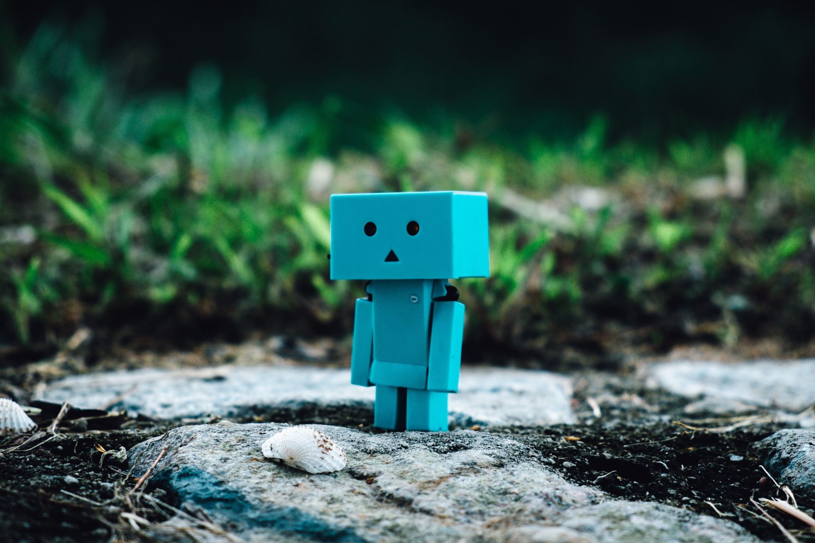 kleine blaue, roboterähnliche Figur steht auf einem Stein, allein wie auf einer 404-Seite